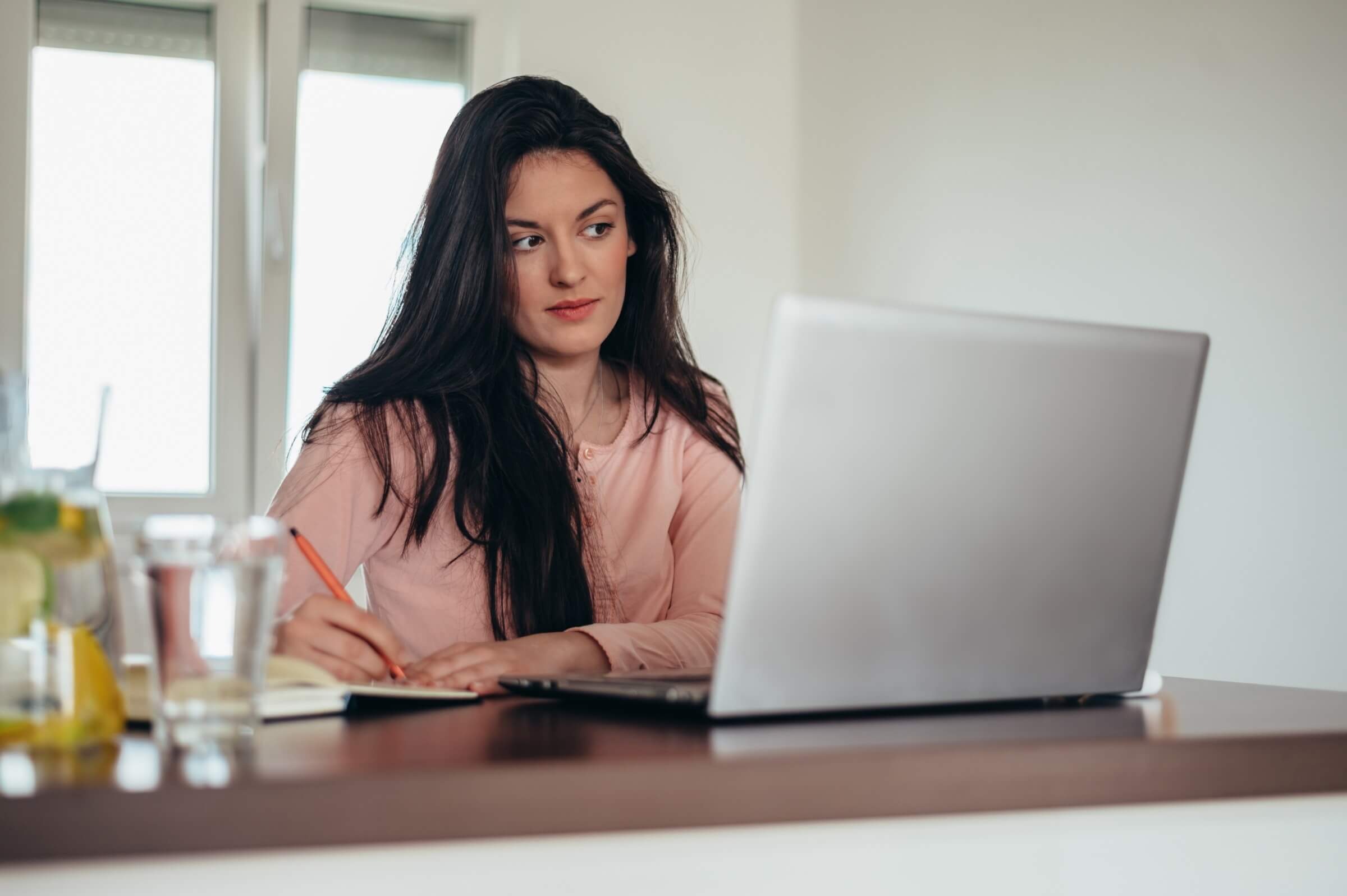 Frau arbeitet zuhause an einem Laptop
